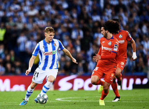 Martin Odegaard of Real Sociedad battles for the ball with