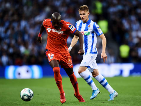 Martin Odegaard of Real Sociedad battles for the ball with