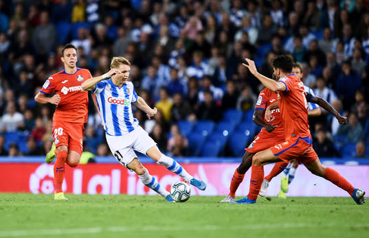Martin Odegaard of Real Sociedad battles for the ball with
