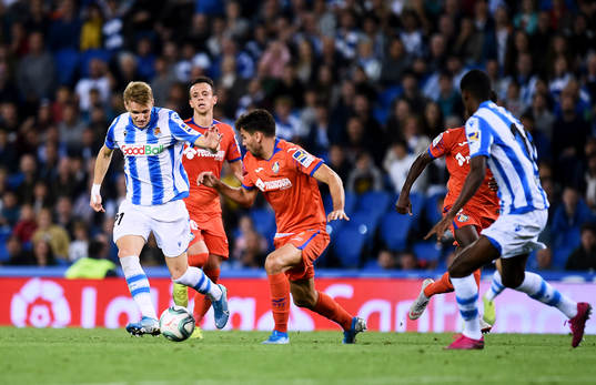 Martin Odegaard of Real Sociedad battles for the ball with