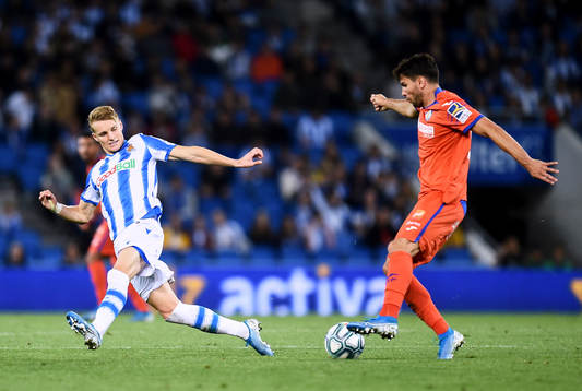 Martin Odegaard of Real Sociedad battles for the ball with