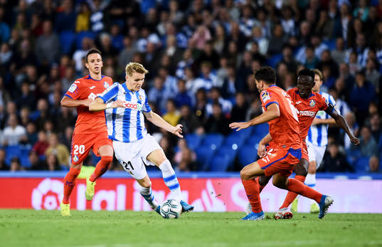 Martin Odegaard of Real Sociedad battles for the ball with