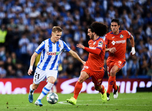 Martin Odegaard of Real Sociedad battles for the ball with