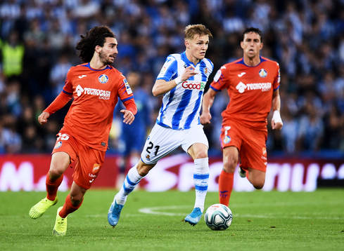 Martin Odegaard of Real Sociedad battles for the ball with