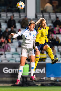 Lucie Harsanyova of Slovakia defends against Nathalie