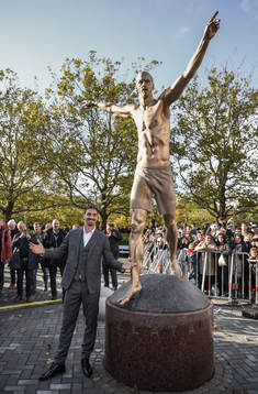Zlatan Ibrahimovic pose with his statue at the revealing
