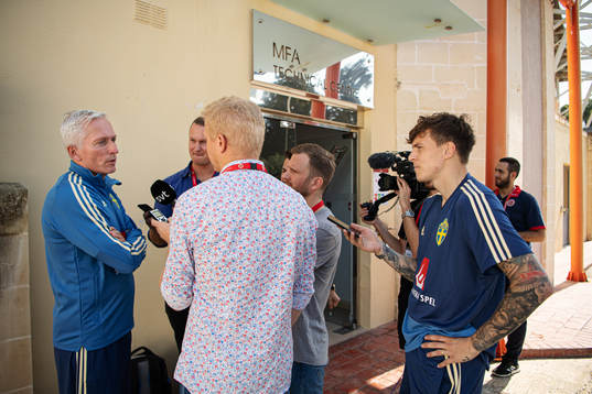 Player Victor Nilsson Lindelöf stands next to reporters