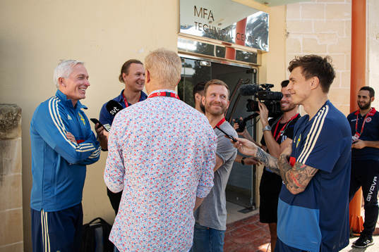 Player Victor Nilsson Lindelöf stands next to reporters