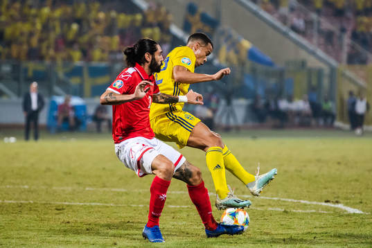 Jonathan Caruana of Malta and Robin Quaison of Sweden