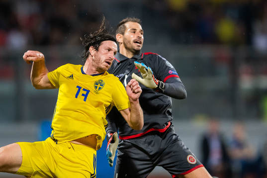 Gustav Svensson of Sweden and goalkeeper Henry Bonello of