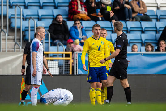 Viktor Gyökeres of Sweden is shown a warning from referee