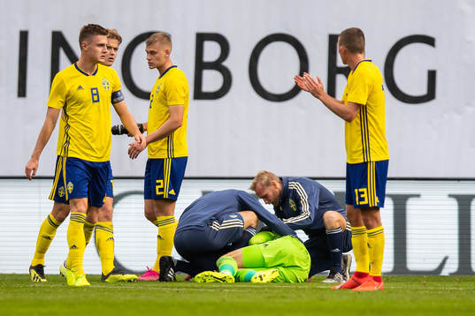 Goalkeeper Pontus Dahlberg of Sweden receives medical