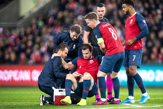 Håvard Nordtveit of Norway with medical attention because