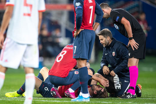 Håvard Nordtveit of Norway recieves medical attention
