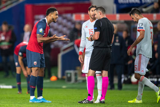 Joshua King of Norway reacts ona call from referee Michael