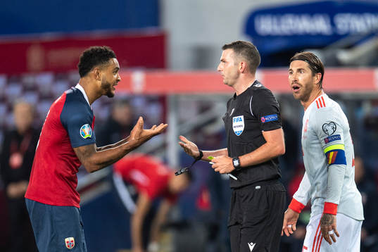 Joshua King of Norway reacts ona call from referee Michael