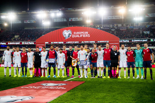 The players of Norway and Spain and the referees line up