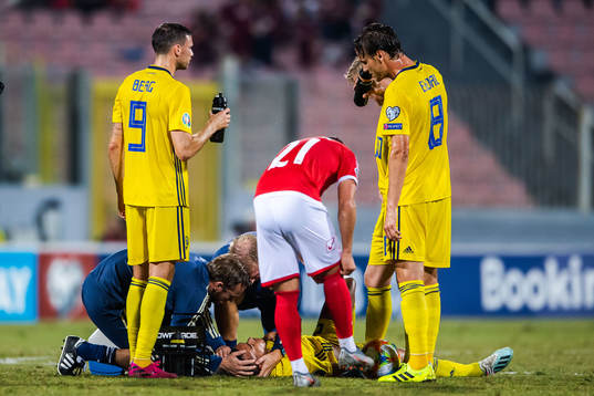 Robin Quaison of Sweden receives medical treatment