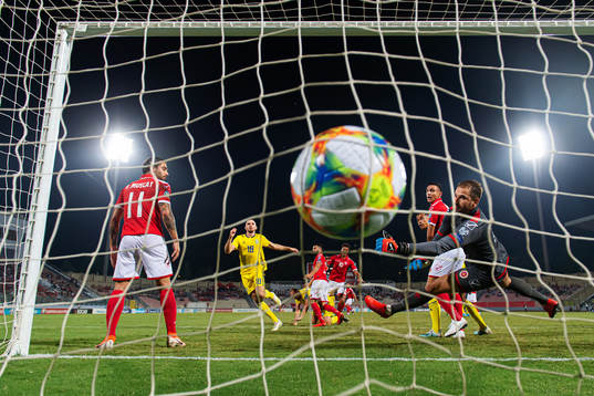 Marcus Danielson of Sweden scores 0-1 behind goalkeeper