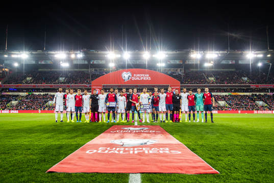 The players of Norway and Spain and the referees line up