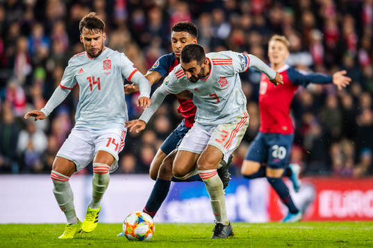 Juan Bernat and Raul Albiol of Spain against Joshua King of