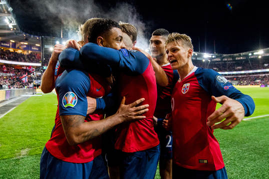 Joshua King of Norway celebrates with Martin Ødegaard and