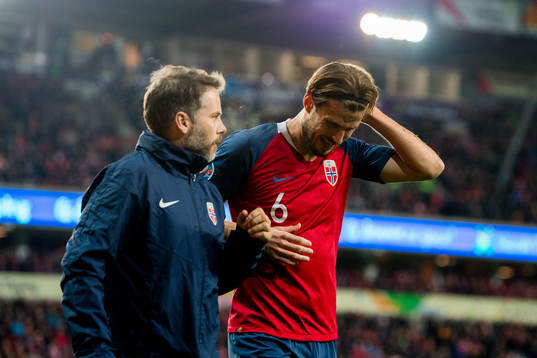 Håvard Nordtveit of Norway receives medical treatment from