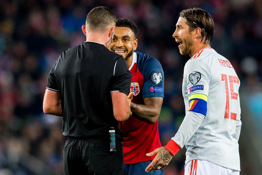 Joshua King of Norway and Sergio Ramos of Spain argue with