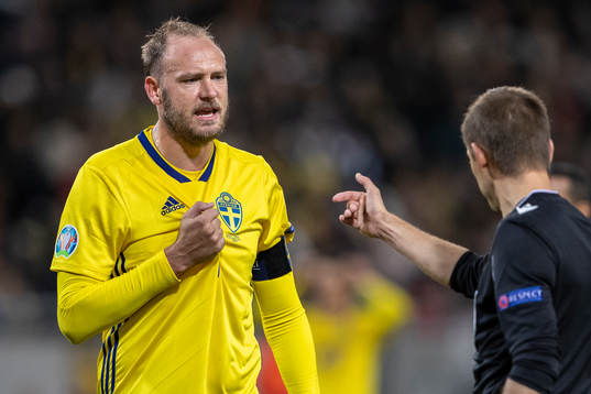 Andreas Granqvist of Sweden and referee Clement Turpin