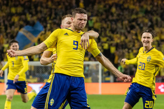 Marcus Berg of Sweden celebrates with Sebastian Larsson and