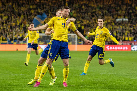 Marcus Berg of Sweden celebrates with Sebastian Larsson and