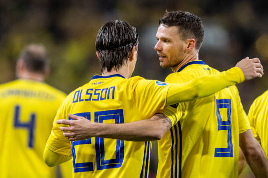 Kristoffer Olsson and Marcus Berg of Sweden celebrate