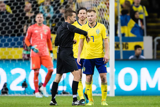 Sebastian Larsson of Sweden gets a yellow card from referee