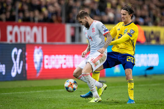 Inigo Martinez of Spain and Kristoffer Olsson of Sweden
