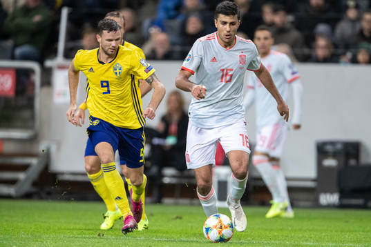 Marcus Berg of Sweden and Rodri of Spain
