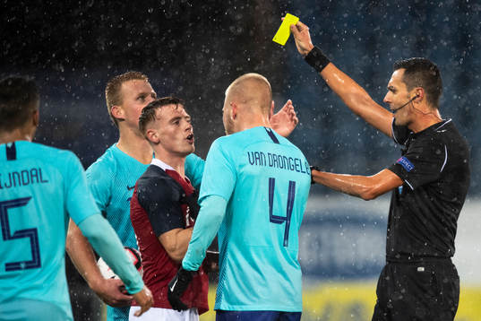 Tobias Heintz of Norway receives a yellow card from referee