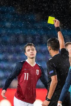 Håkon Evjen of Norway receives a yellow card from referee