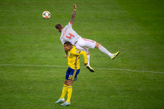 Robin Quaison of Sweden and Inigo Martinez of Spain