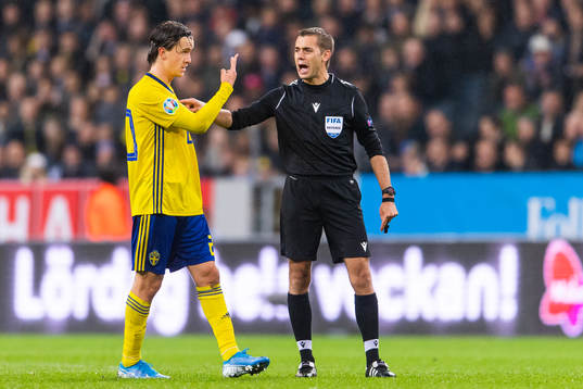 Kristoffer Olsson of Sweden in a discussion with referee
