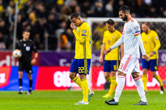 Robin Quaison of Sweden and Raul Albiol of Spain look
