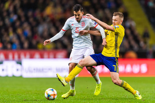 Sergio Busquets of Spain and Sebastian Larsson of Sweden