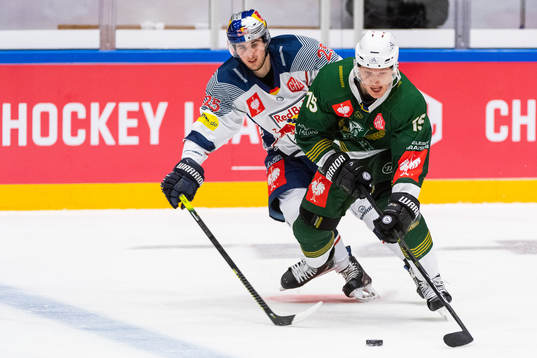 Philipp Mass of Red Bull Munich compete for the puck with