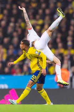 Robin Quaison of Sweden and Inigo Martinez of Spain compete