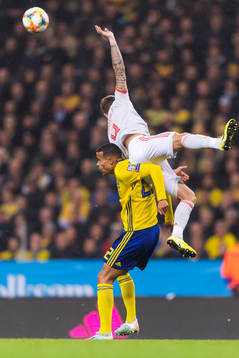 Robin Quaison of Sweden and Inigo Martinez of Spain compete