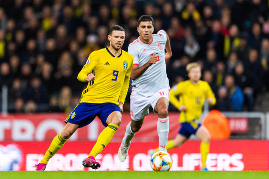 Marcus Berg of Sweden and Rodri of Spain compete for the