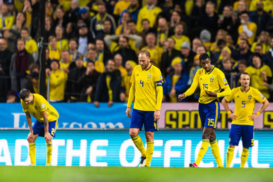 Andreas Granqvist and Alexander Isak look dejected