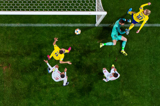 Marcus Berg of Sweden scores 1-0 behind goalkeeper David de