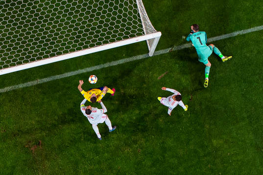 Marcus Berg of Sweden scores 1-0 behind goalkeeper David de