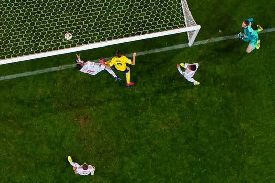 Marcus Berg of Sweden scores 1-0 behind goalkeeper David de