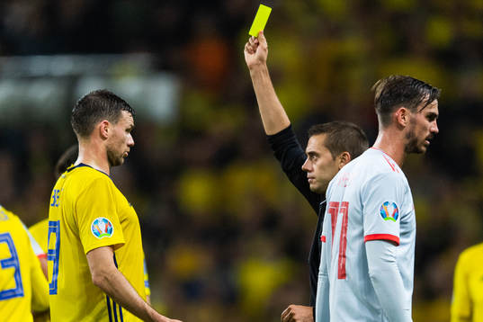 Marcus Berg of Sweden receives a yellow card from referee